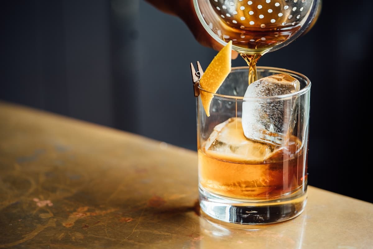 Cocktail being poured at the bar
